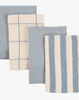 Set of four textured towels with plaid and stripe patterns on a white background