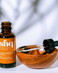 ishq organic beard oil bottle with dropper on a white background