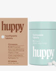 huppy toothpaste tablets packaging with a mint green container and brown box on a white background