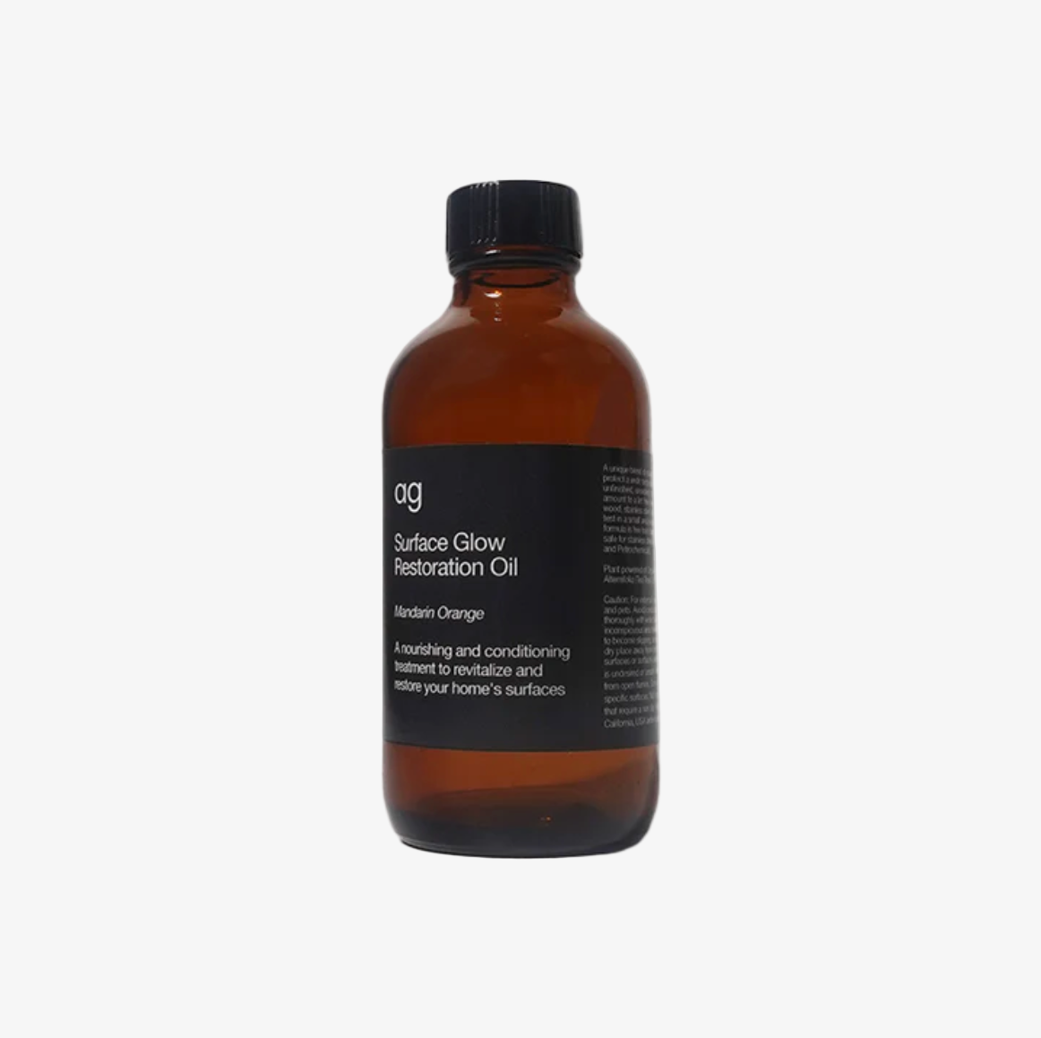Brown bottle of Surface Glow Restoration Oil with a black label on a white background