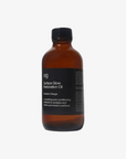 Brown bottle of Surface Glow Restoration Oil with a black label on a white background